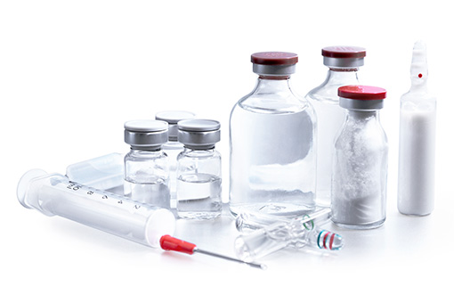 pharmaceutical industry. Production line machine conveyor with glass bottles ampoules at factory